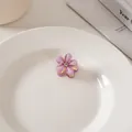 Detail einer lila Blumen-Haarklammer mit glitzernden Blüten und zentralem Strass - Einzelstück / Lila