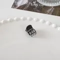 Detailed close-up of a mini black metal hair claw clip on a white ceramic tray - Mini Square Claw - Gunmetal