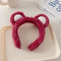 Close-up of soft plush pink bear ears headband displayed on a beige decorative tray - Dragon Fruit