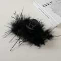 Detail shot of elegant black feather hair claw clip on aesthetic white background - Black
