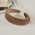 Detail of plush brown faux rabbit fur headband with handmade label in a decor basket - Brown
