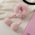 Detailansicht des rosa Plüsch-Haargummis mit weichen Pompons und hängenden Bändern - Rosa
