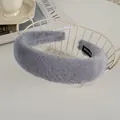Detailed view of gray faux rabbit fur headband with handmade label in a lifestyle setting - Gray