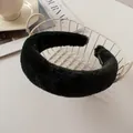 Close-up of black plush faux rabbit fur headband with wide thick padded texture - Black
