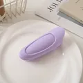 Close-up of a purple silicone scalp massage hair brush on a white decorative plate - Purple