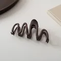 Macro detail of wave-shaped matte dark brown hair claw clip on a minimalist background - Dark Coffee