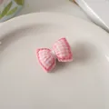 Detailed view of pink plaid fabric bow with delicate hand-stitched borders and soft filling - Pink Bowknot