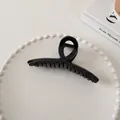 Macro detail of a large glossy black hair claw clip with strong metal spring - Cross Style (6#)