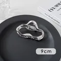 Detail shot of a 9cm silver metal hair claw clip with a wave-shaped cutout design - Oval (14#)