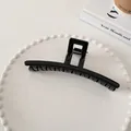 Detail of glossy black hair claw clip with square handle on a decorative white pearl tray - Large Straight Style (5#)
