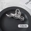 Detail of 12cm silver metal hair claw with ribbon design and central pearl accent - Pearl Bow (29#)