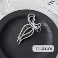 Detail of 11.5cm silver metal hair claw clip with bow design on a minimalist background - Vertical Bow (26#)
