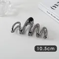 Detail view of a 10.5cm wave-shaped large gunmetal grey metallic hair claw clip - Lines (4#)