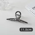 Detail showing an 11.5cm large dark grey metal hair claw clip with a sleek circular design - Cross (13#)