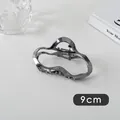 Detail of a 9cm wave-shaped gunmetal silver hair claw clip with metallic finish - Oval (15#)