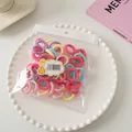 Detailed macro of assorted colorful seamless elastic hair ties in a clear poly bag - Multicolor Style / Macaron Multicolor