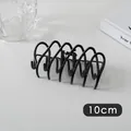 Detailed view of a 10cm black metal wave hair claw clip with cross design on grey surface - Fence Style (9#)