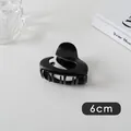 Detail view of a 6cm matte black heart-shaped hair claw clip with sleek fluid lines - Small Round/Heart (22#)