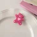 Detailed view of a cute rose red acrylic bear hair clip on a vintage white porcelain plate - Raspberry Pink - Duckbill Clip