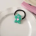 Close-up of mint green bear hair tie with pink heart on a white ceramic tray - Green Pink - Hair Tie