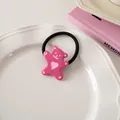 Close-up of cute pink resin bear hair tie with heart detail on a white ceramic plate - Raspberry Pink - Hair Tie