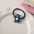 Detailed view of a cute blue bear hair tie with heart design on a white ceramic plate - Navy Blue - Hair Tie