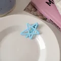 Detail of light blue hollow star hair clip on a white plate with aesthetic background - Light Blue Star