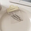 Dettaglio di fermagli in metallo argento opaco con design ovale vuoto su vassoio ceramica - Stile Ovale Cavo Snello (2#) / 6cm / Argento