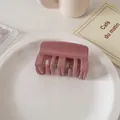 Detail of a glossy mauve square hair claw clip placed on a minimalist ceramic plate - Korean Pink
