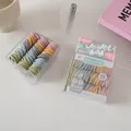 Close-up of baby hair ties in a clear jewel box with soft Morandi pastel colors - Macaron Color