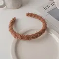Close-up of brown faux shearling headband texture on a minimalist lifestyle setting - Brown