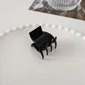 Minimalist glossy black claw clip for hair styling on a white decorative porcelain plate - Medium Square Claw - Black