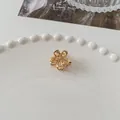 Mini golden hollow floral hair claw clip with elegant metallic spring mechanism - Hollow Flower - Gold