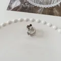 Mini silver heart-shaped metal hair claw clip with rings displayed on a white plate - Circle Heart - Silver