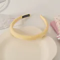 Detail of light yellow fabric headband with handmade label on cloud tray - Yellow