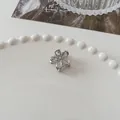 Mini silver flower hair claw clip with polished metallic finish for half-up hairstyles - Hollow Flower - Silver