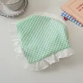 Detail shot of green checkered floral hair scarf with ruffled lace edges on a table - Green Plaid