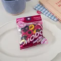 Detail of candy-colored elastic hair ties in baby size on a white ceramic plate - Mixed Multicolor (Pink, Yellow, Dark Blue)