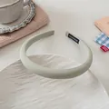 Detail of light green padded headband with handmade label on white ceramic plate - 3# Green