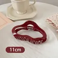 Detail view of 11cm dark red wavy shark hair clip on an aesthetic lifestyle background - Wavy Cloud Style / Large / Burgundy