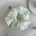 Detailed close-up of light mint green satin scrunchie with soft pleated texture and silk-like shine - 4# Fresh Green