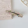 Close-up of silver metal hair clip featuring colorful enamel polka dots on stone surface - 6cm / Hollow Oval Multicolor Dot Style (No.1)