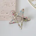 Detail of silver star hair clip with colorful polka dots on a textured stone - 5.5CM
