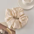 Macro detail of ivory cotton hair scrunchie with intricate floral petal embroidery - White Circle Style