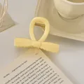 Détail d'une pince à cheveux nœud jaune crème avec ressort en métal doré - Décoration de Nœud / 8cm / Jaune Lait