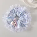 Close-up of a striped blue lace scrunchie with a pink bow and a Hand Made label - Blue and White Stripes
