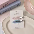 Pink floral and blue butterfly acrylic hair clips set on a decorative white plate - Blue Floral And Butterfly Style