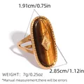 Gold stainless steel oval tiger eye ring with beaded edge and geometric details - Adjustable / Brown (Tiger Eye Texture)