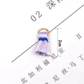 Detail view of 2cm purple mini tassel with blue binding and gold ring connector - Purple