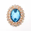 Oval gold alloy accessory with large blue gemstone and sparkling rhinestone border - Dark Blue